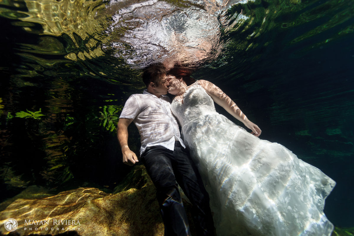 KissingNewlywedsFloatUnderwaterInCenote