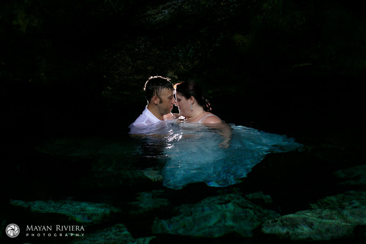 NewlywedsEmbraceInCenoteWater