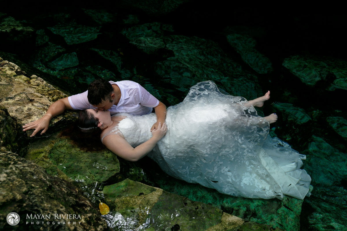 NewlywedsReclineInCenoteKissing