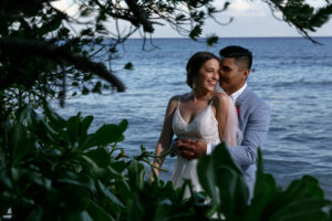 NewlywedsEmbraceByTheBeach