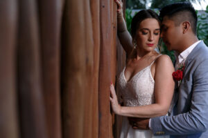 NewlywedsEmbraceByWall