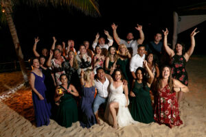 CheeringWeddingGuestsWithNewlywedsInDroneShot