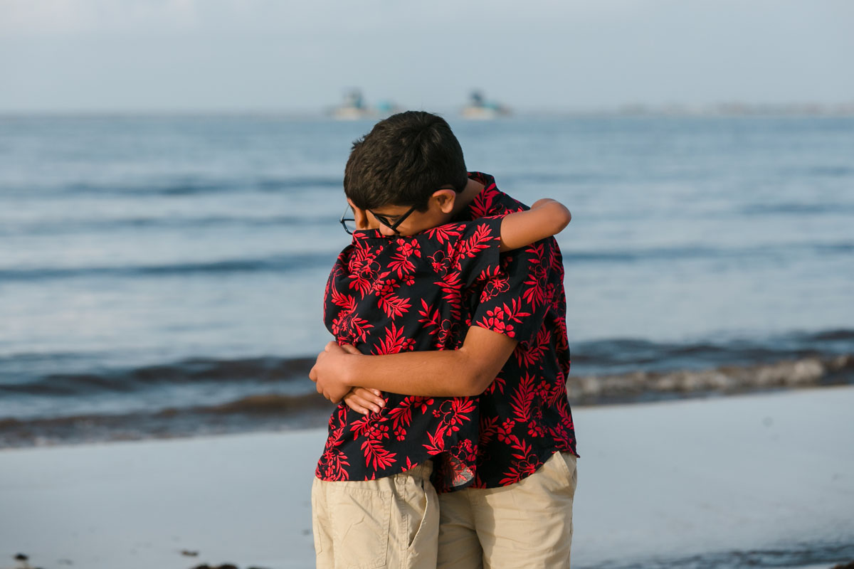 SmilingSonsHugOnBeach