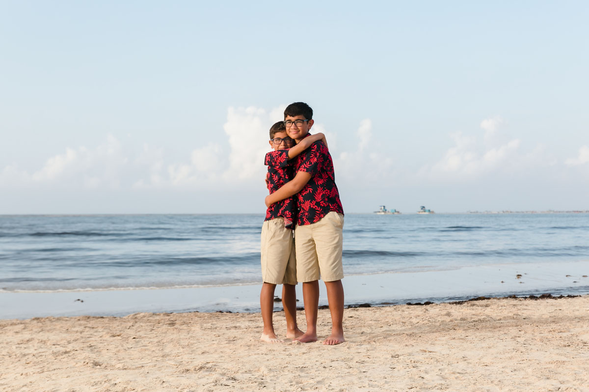 SmilingSonsHugOnBeach