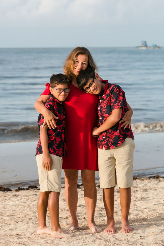 SmilingAuntieHugsNephewsOnBeach