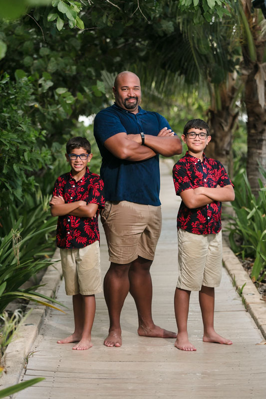 RyannAndSonsStandOnPathwayWithArmsFolded