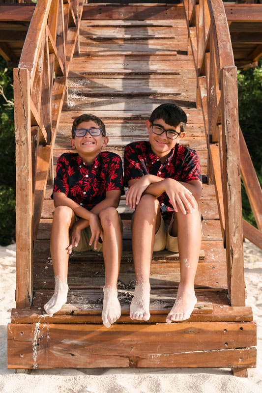 BoysSitOnTowerStepsSmiling