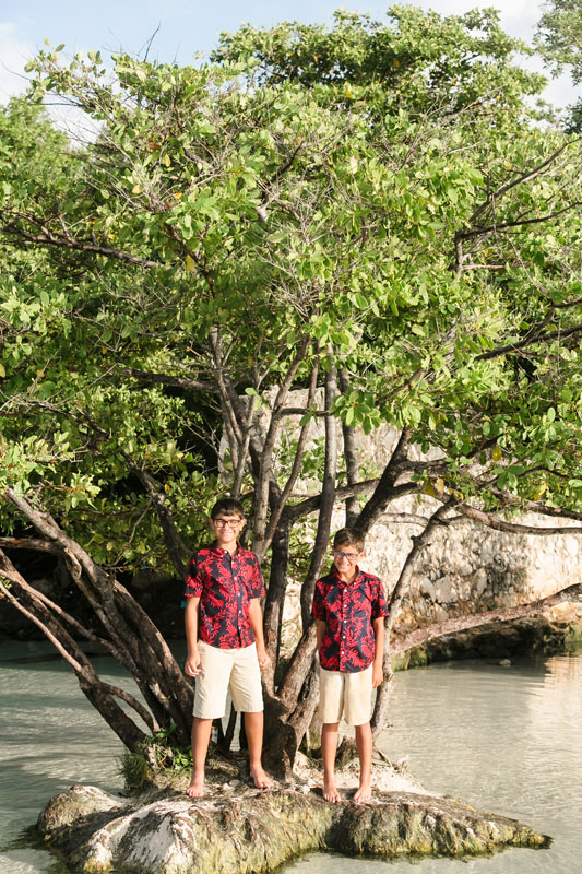 BoysStandOnTinyIslandByJungleTree