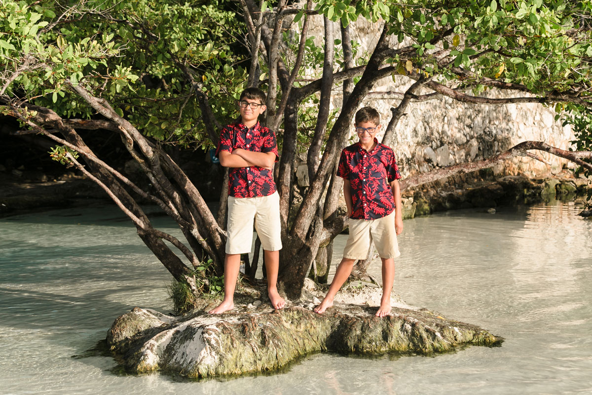 BoysStandOnTinyIslandByJungleTree