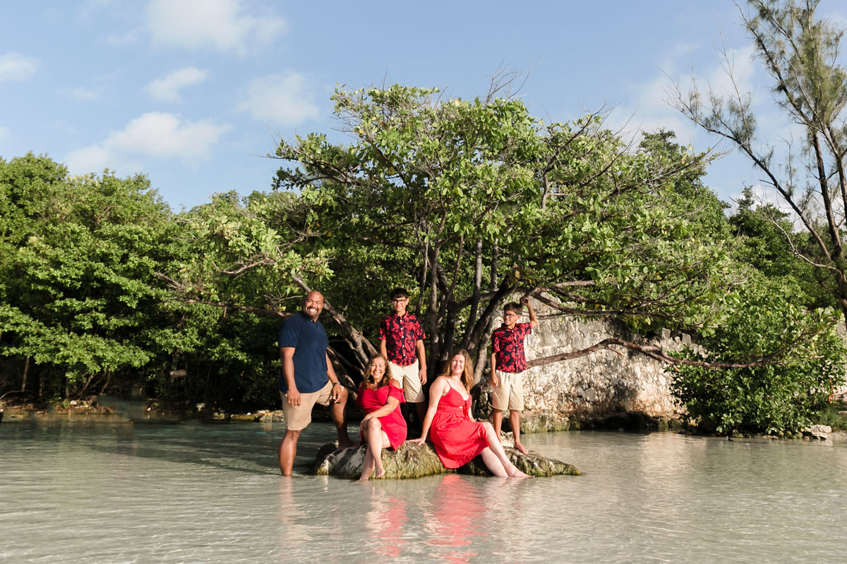 FamilyPosesOnTinyIslandByJungleTree