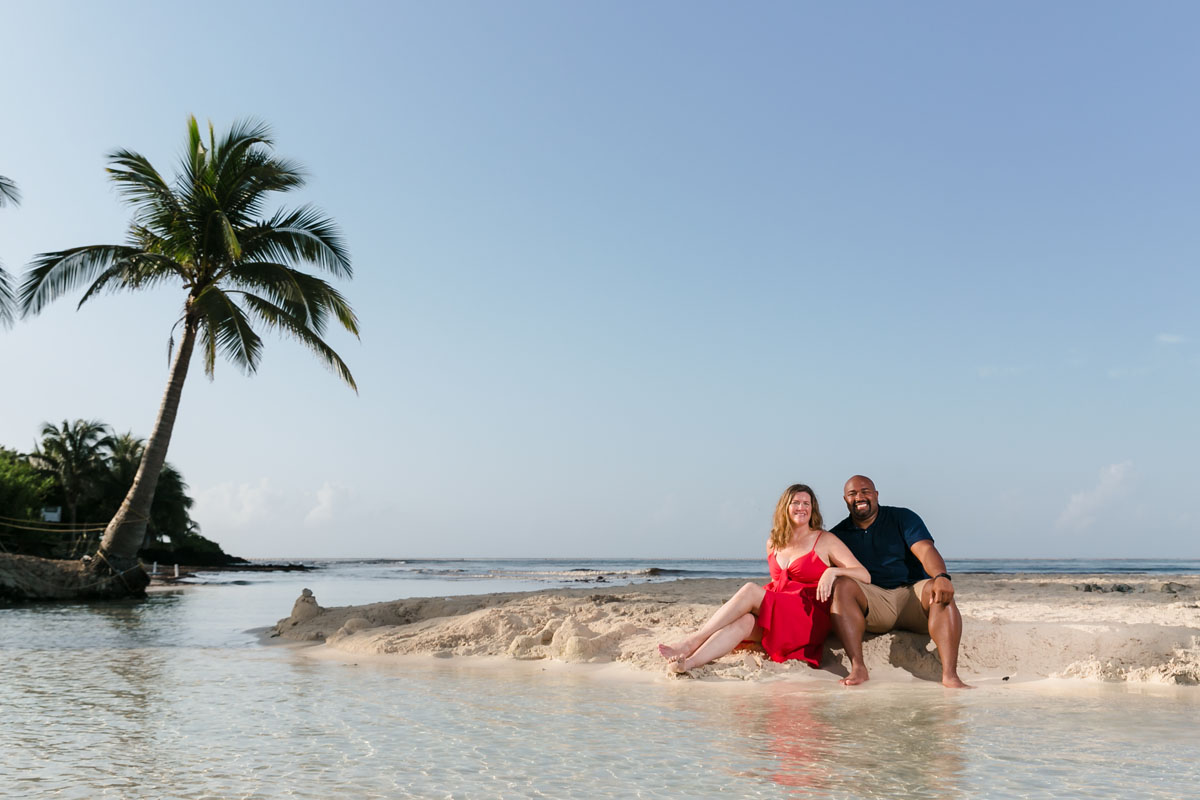 RyannAndWifeSitOnBeachByShallowTidePool