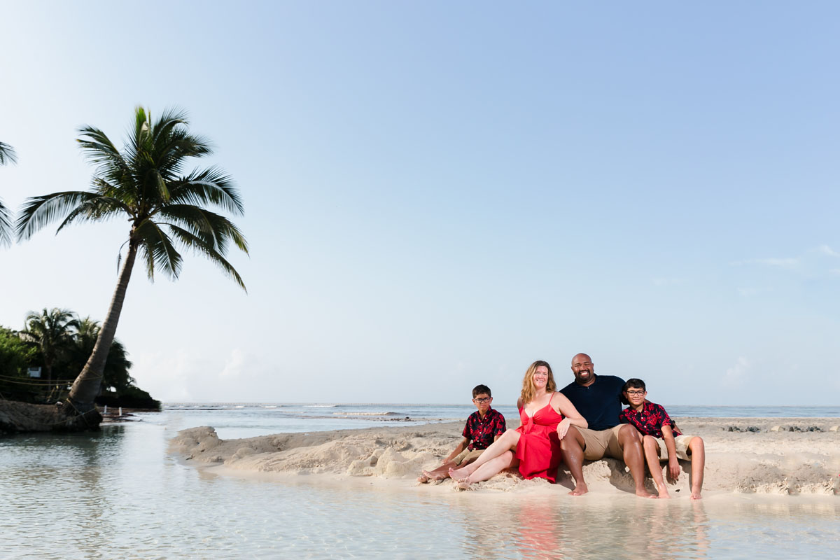 RyannAndFamilyPoseOnBeachByShallowTidePool