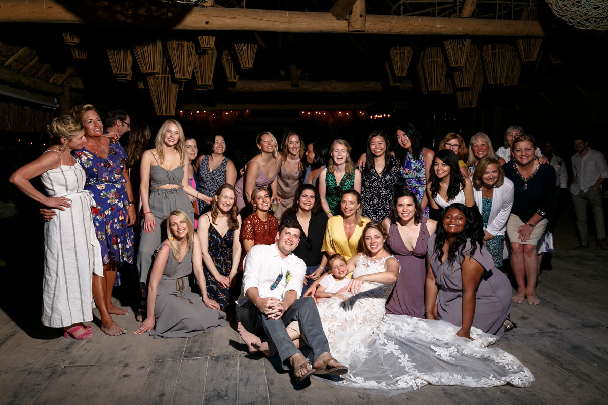 NewlywedsReclineInFrontOfLadiesGroup