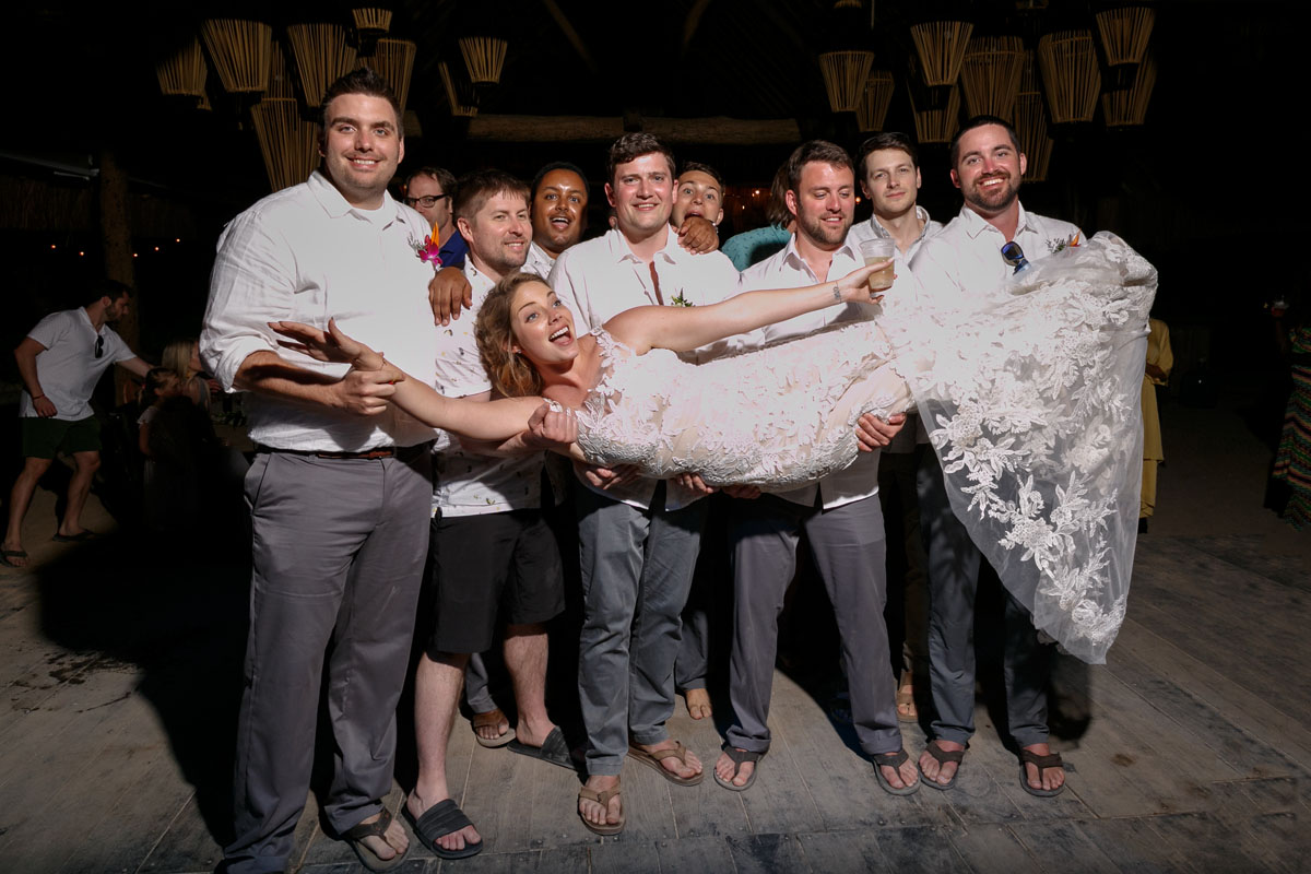 GuysHoldingLaughingBrideInTheirArms