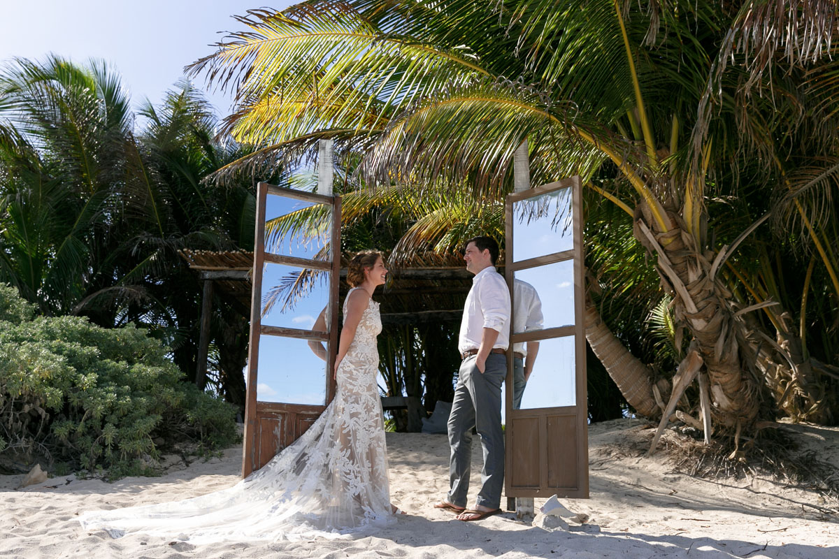 WeddingCouplePoseInBeachDoorway