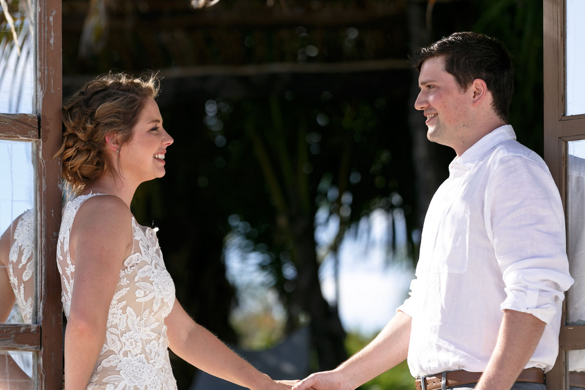 WeddingCouplePoseInBeachDoorway