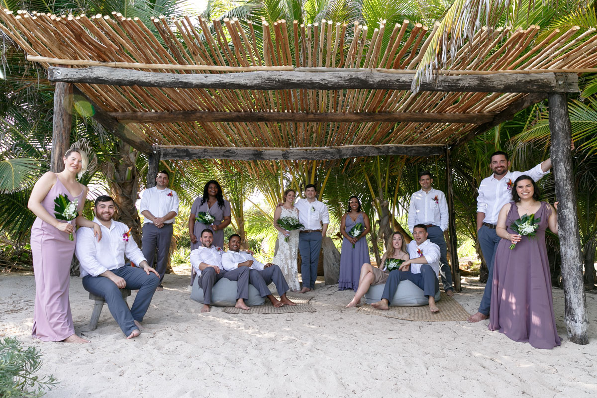 NewlywedsPoseWithWeddingPartyInPalapa