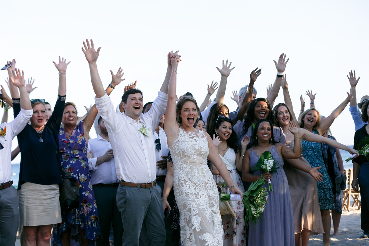 NewlywedsPoseWithCheeringGuestsInDroneShot