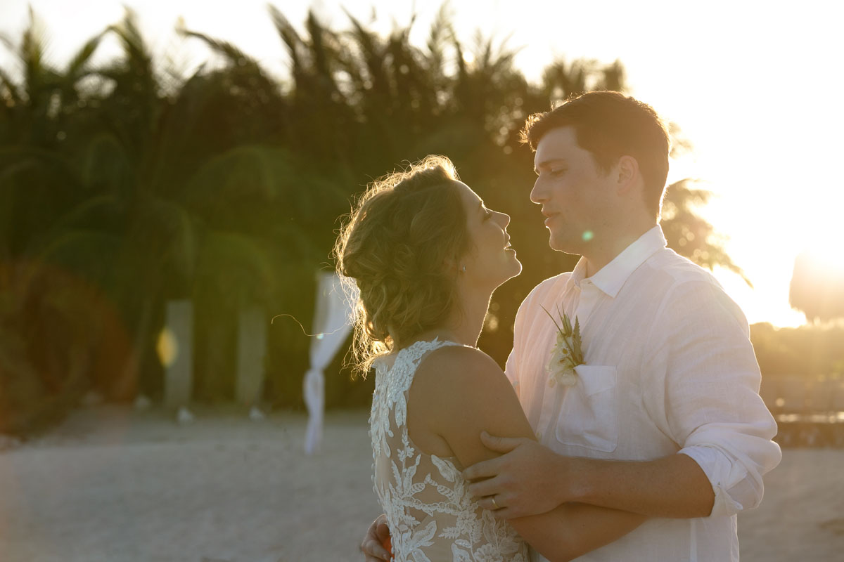 NewlywedsEmbraceOnBeach