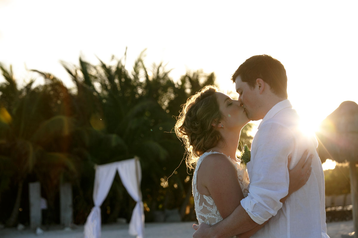 NewlywedsKissOnBeach