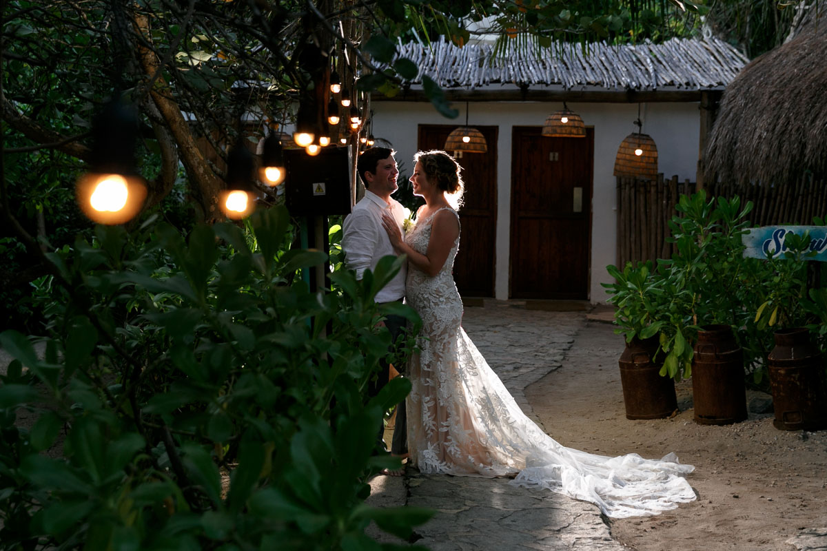 Newlyweds embrace on jungle garden path