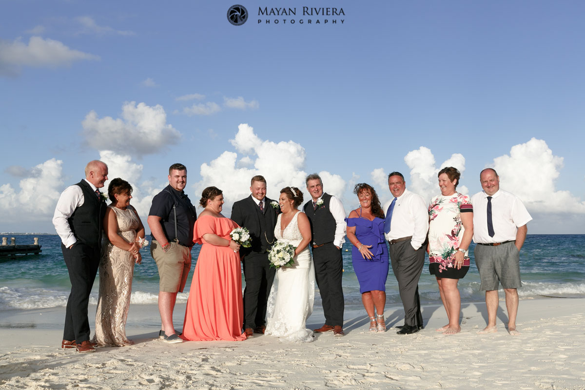 RiuCancunNewlywedsPoseWithGuestsOnBeach