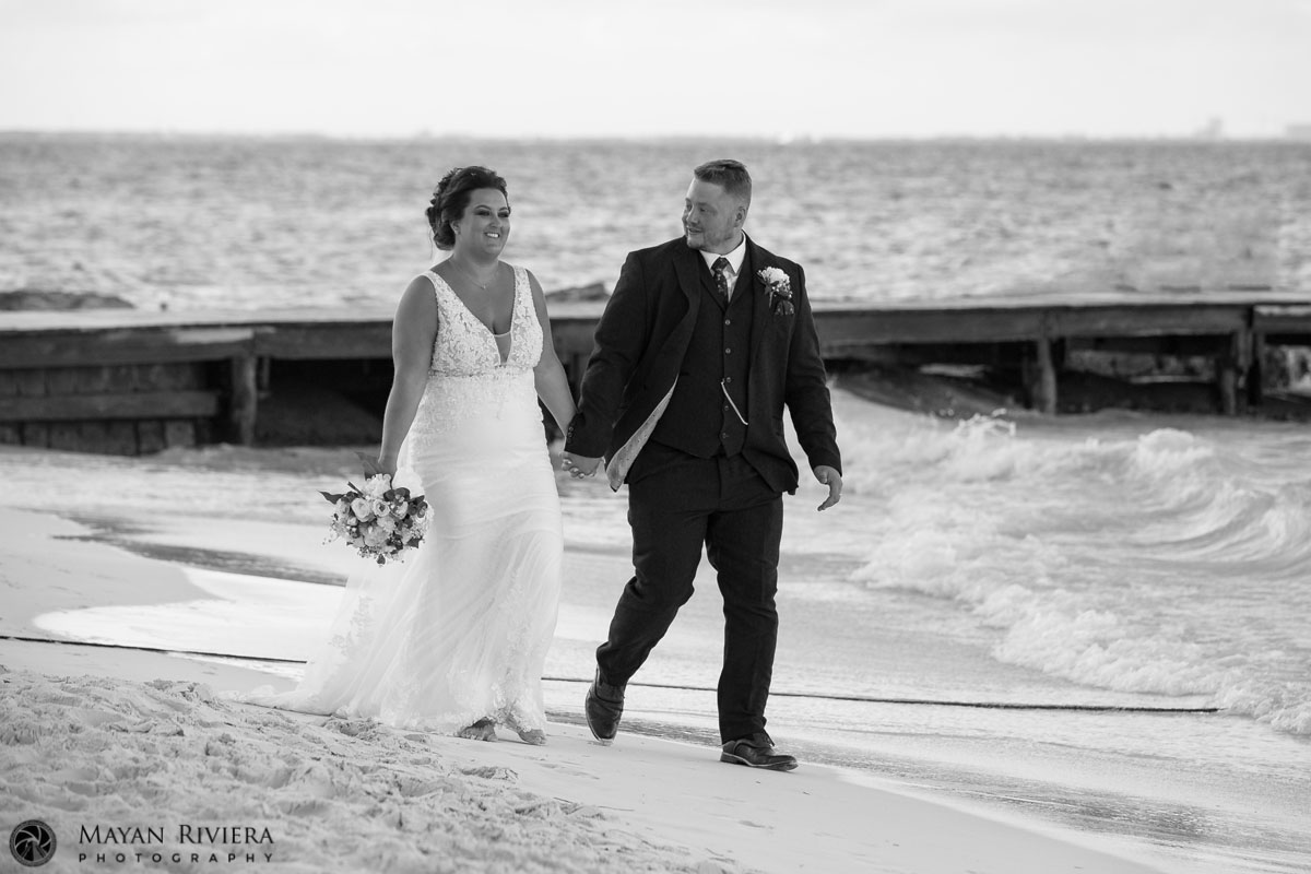 NewlywedsHoldHandsOnBeachwalk