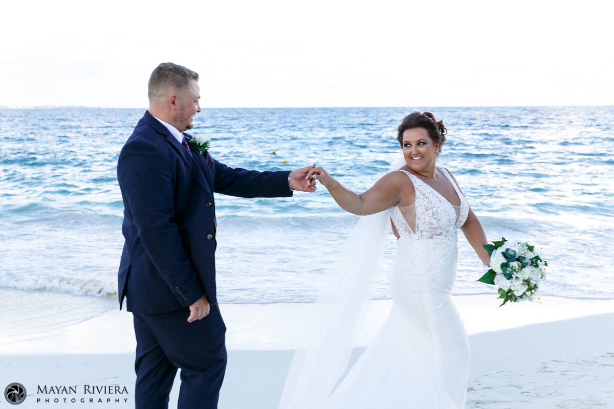 NewlywedsHoldHandsOnBeachwalk