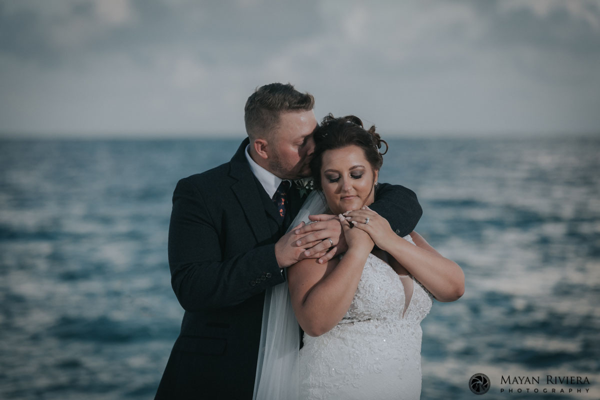 NewlywedsEmbraceOnBeach