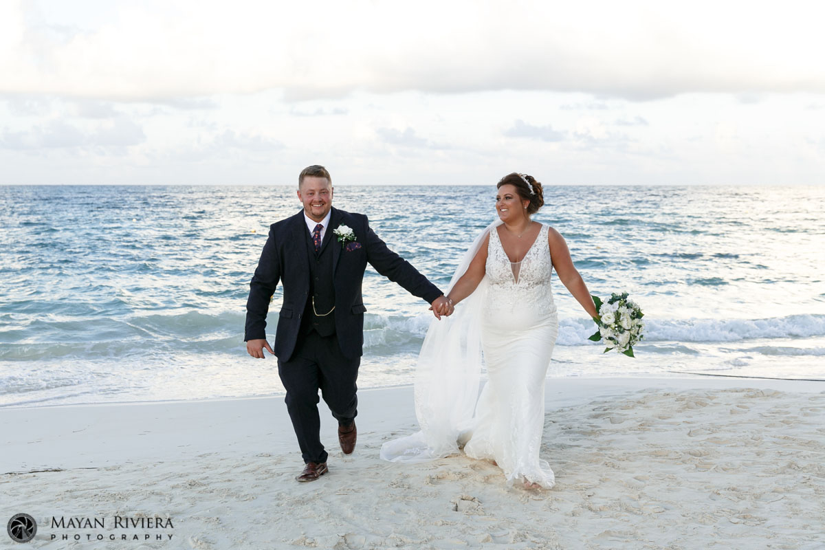 SmilingNewlywedsRunOnBeach