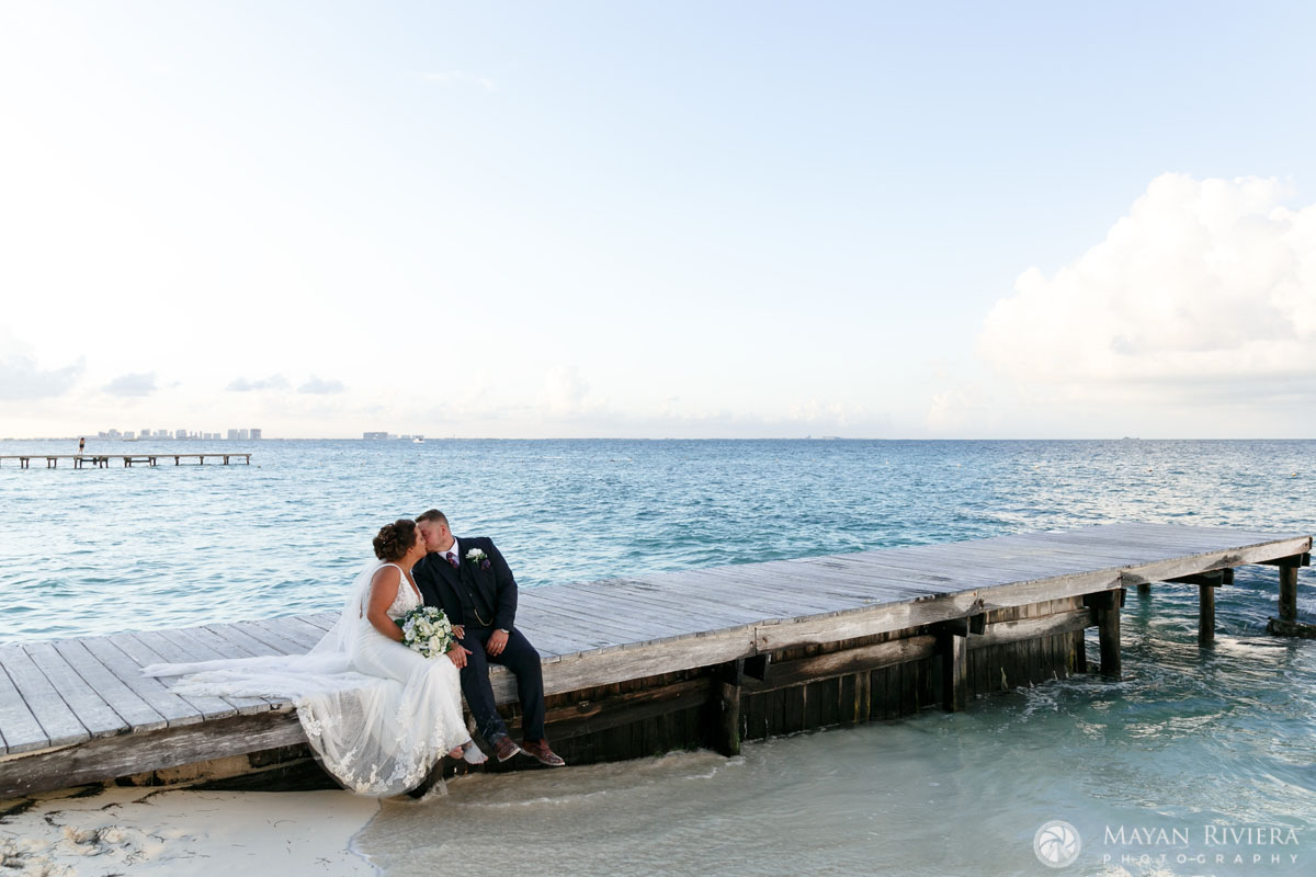 Riu Cancun newlyweds kissing on pier