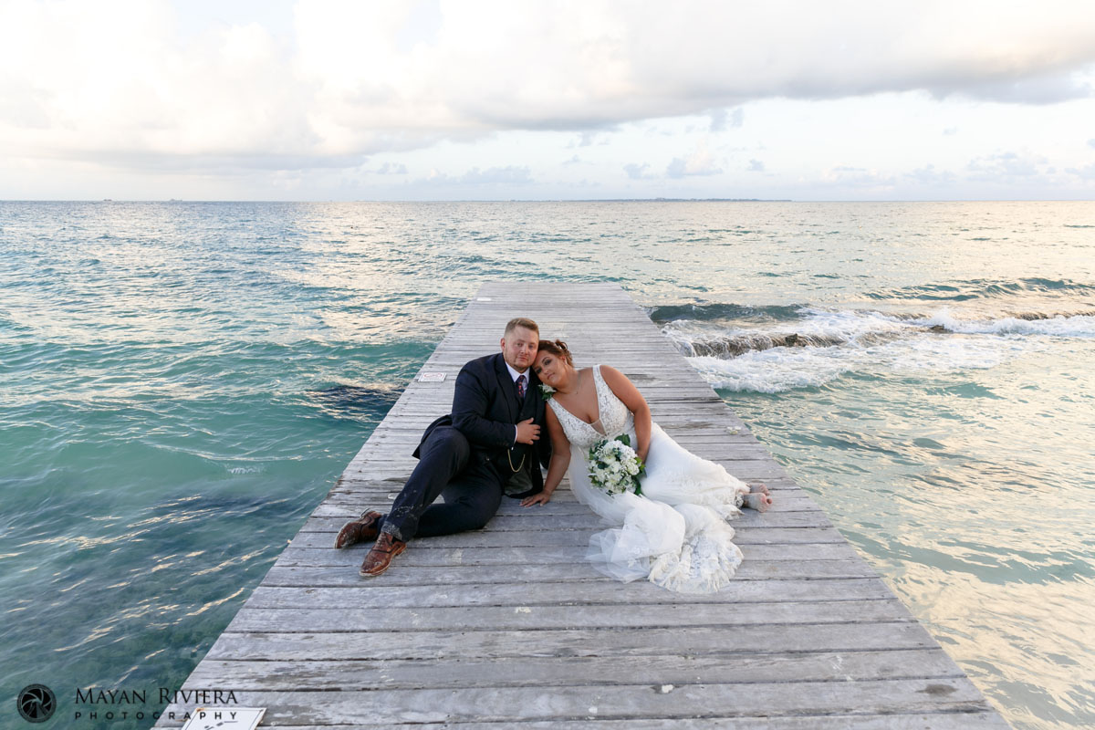 RiuCancunNewlywedsEmbraceOnPier