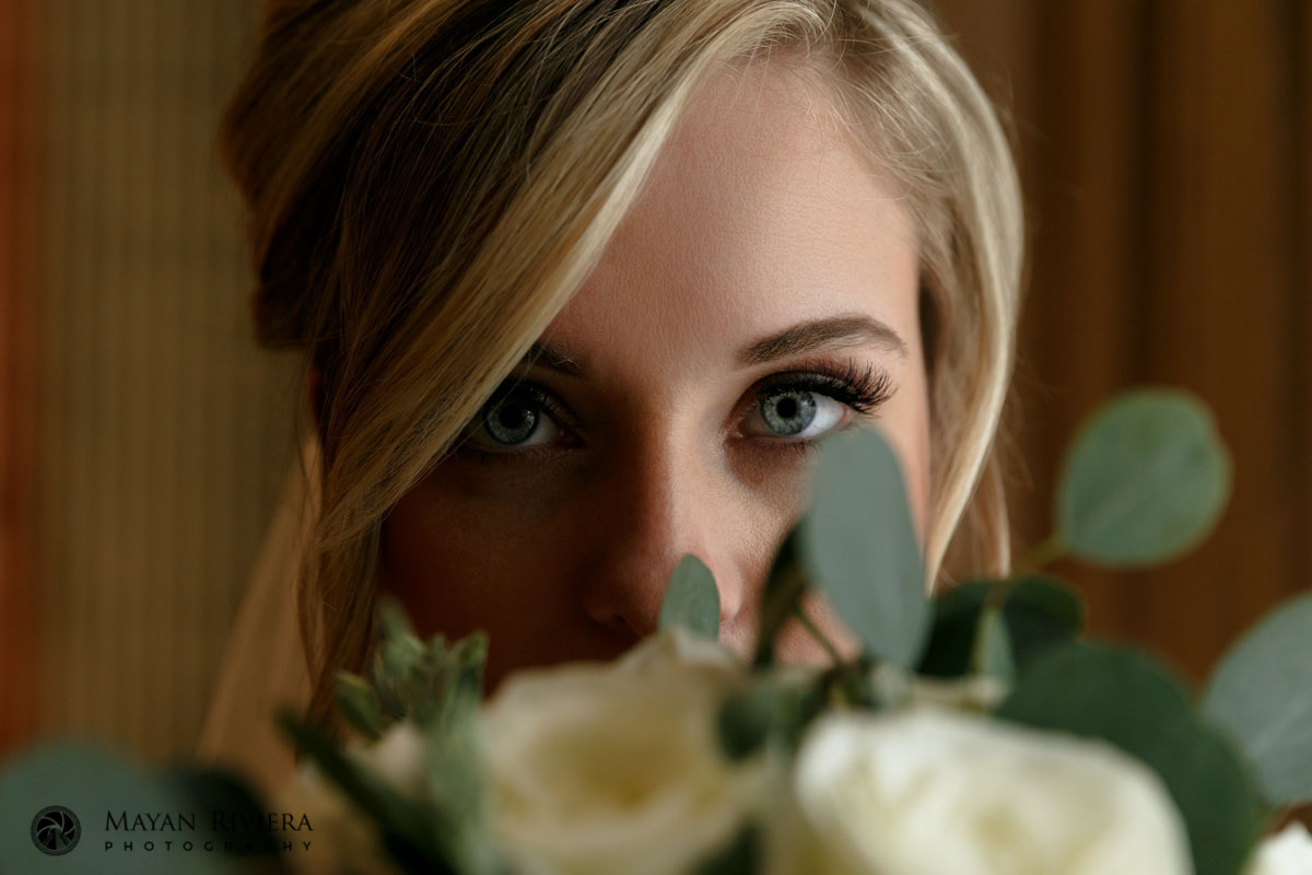 BeautifulBrideLooksOverBouquet