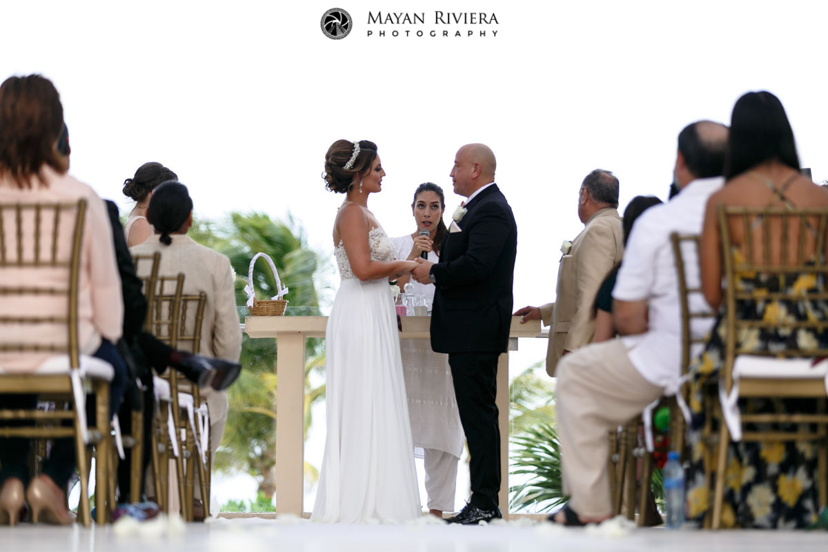 WeddingCoupleHoldHandsAtCeremony