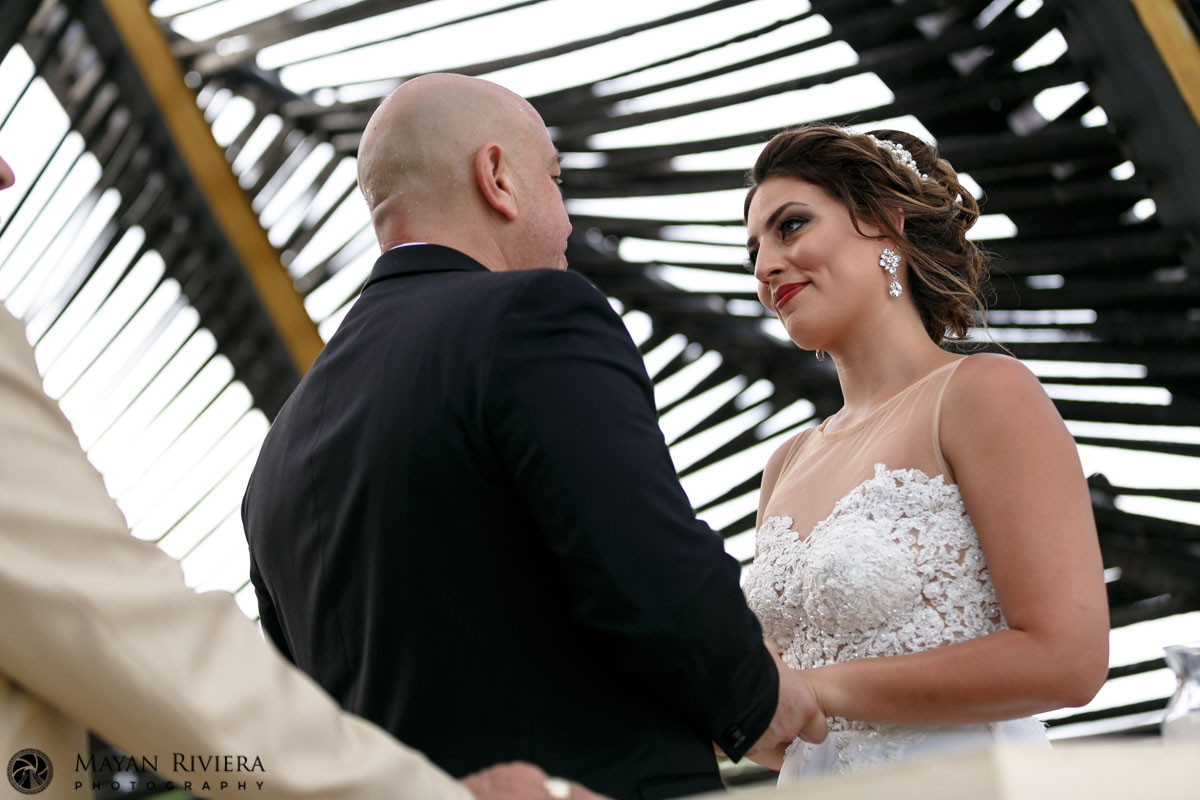 WeddingCoupleHoldHandsAtCeremony