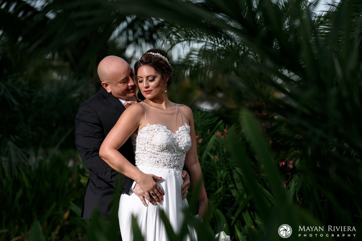 NewlywedsEmbraceOnGardenLawn