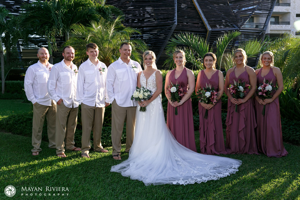 NewlywedsPoseWithWeddingPartyOnLawn