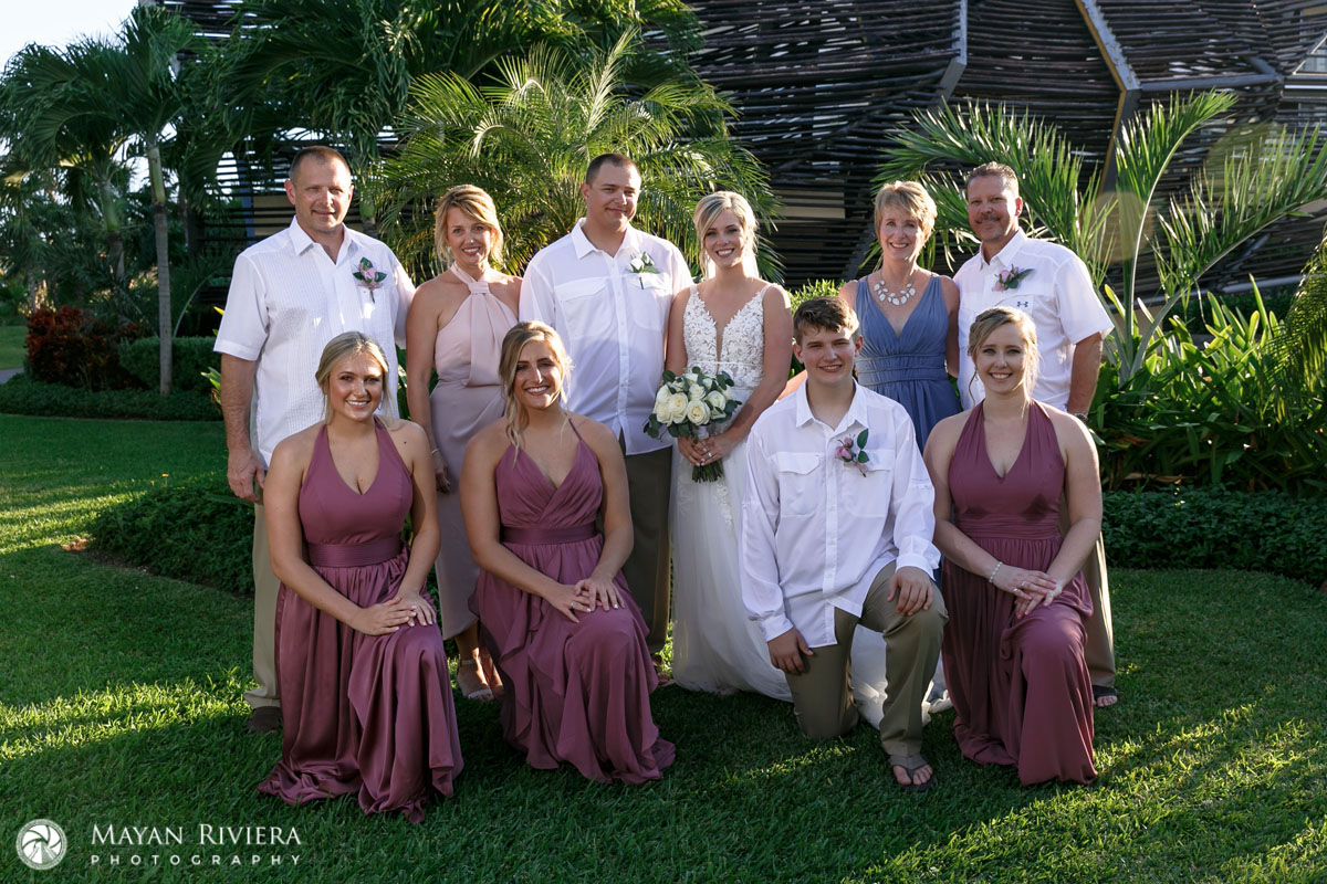 NewlywedsPoseWithFamilyOnLawn