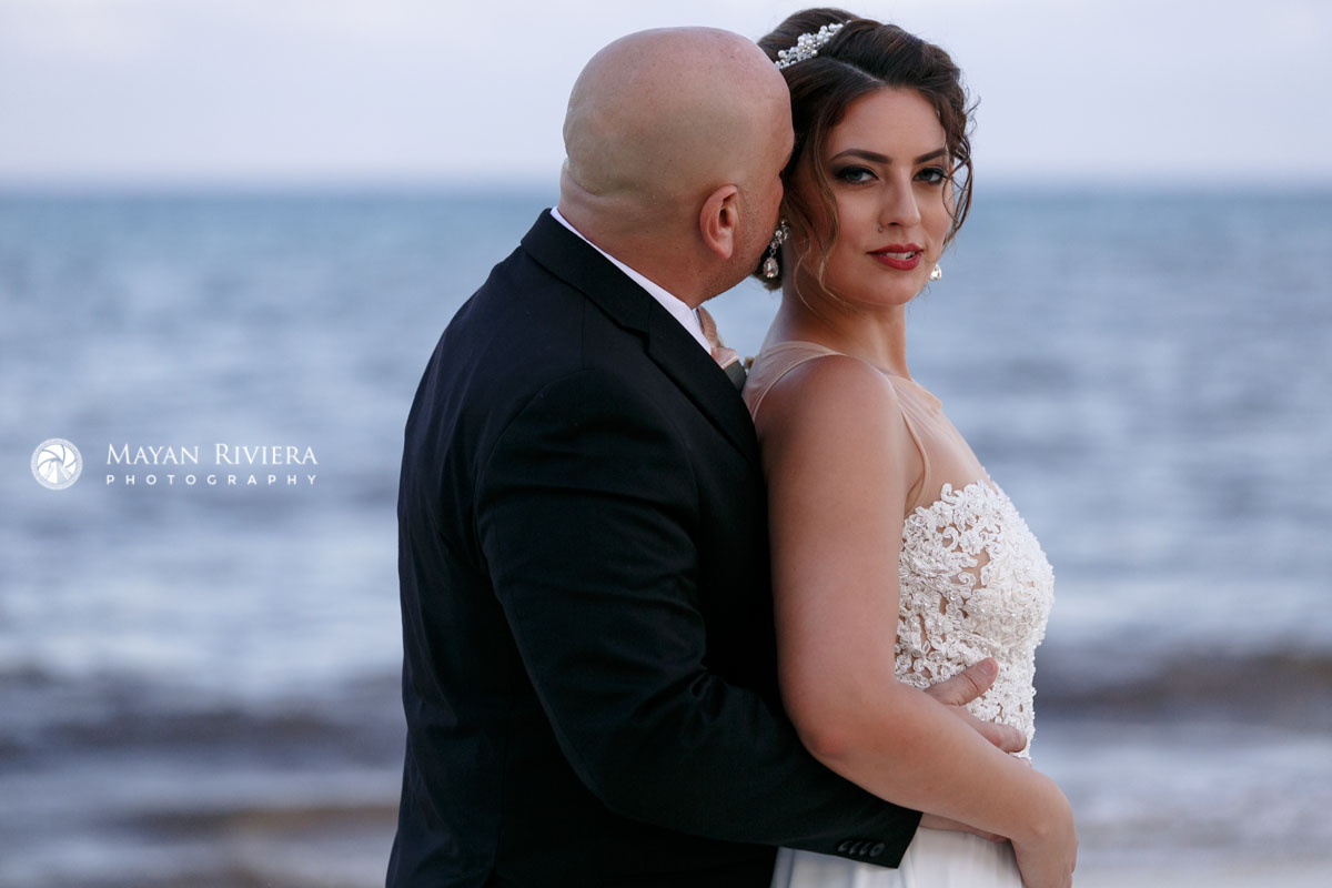 NewlywedsEmbraceOnBeach