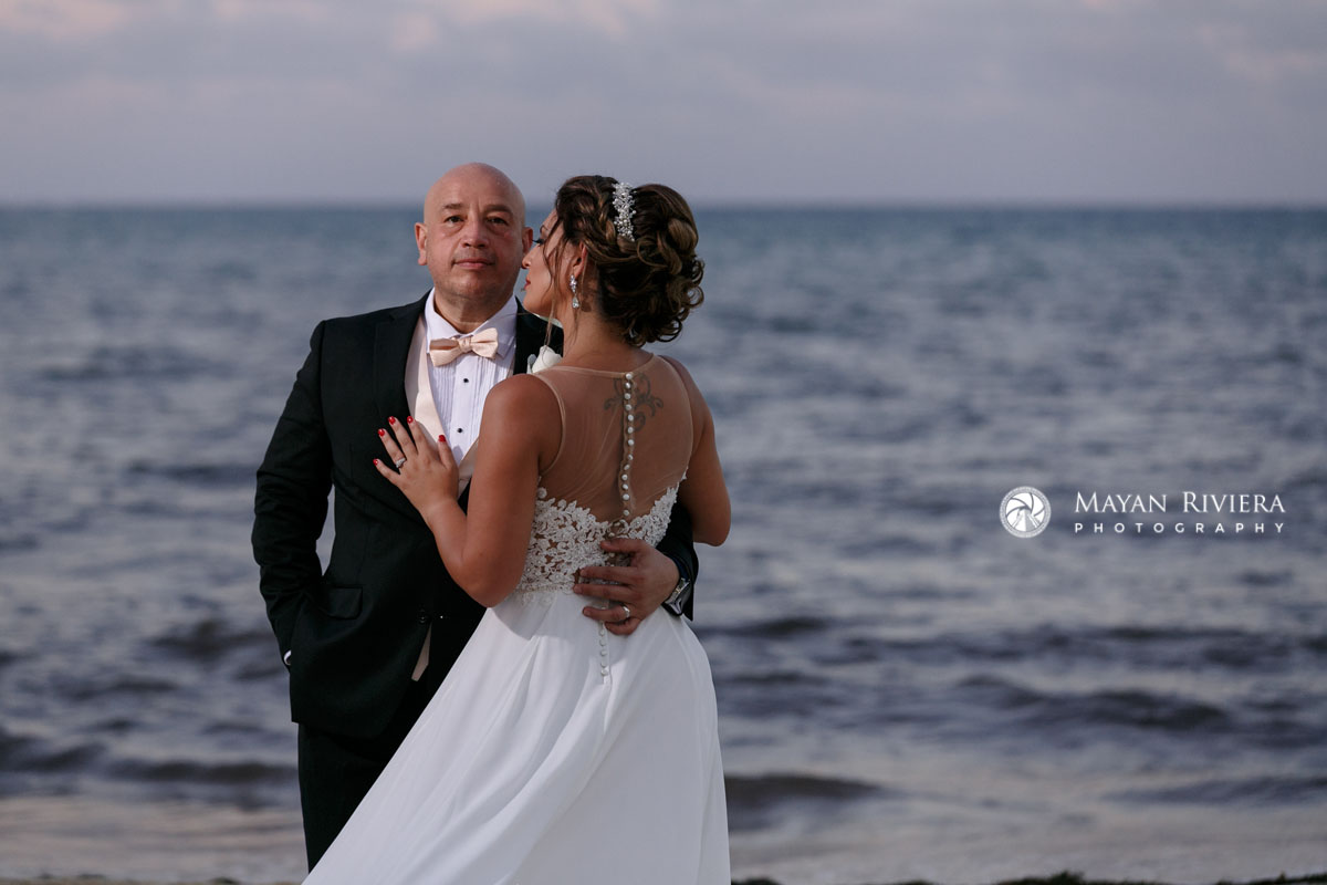 NewlywedsEmbraceOnBeach