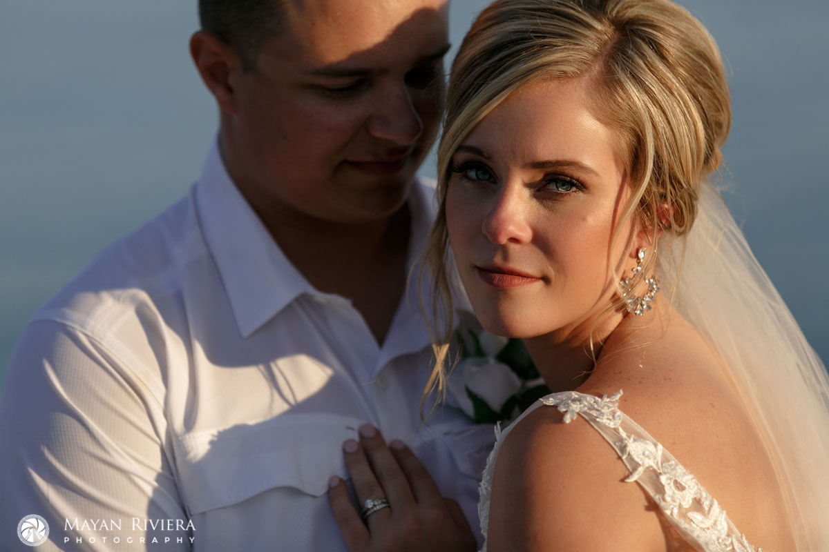 NewlywedsEmbraceOnBeach