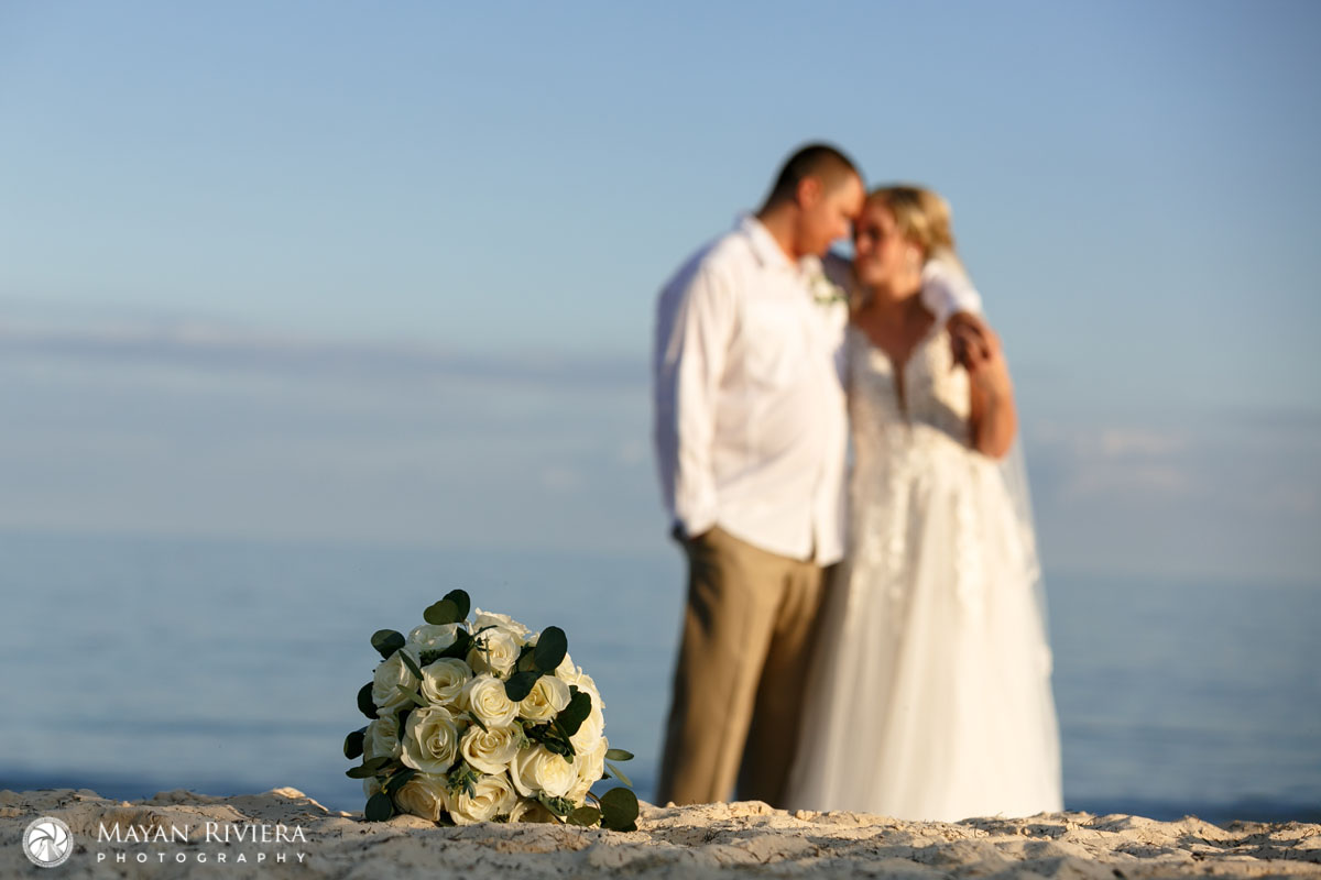 NewlywedsEmbraceOnBeach