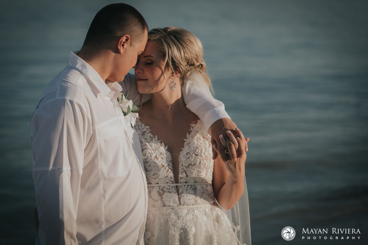 NewlywedsEmbraceOnBeach