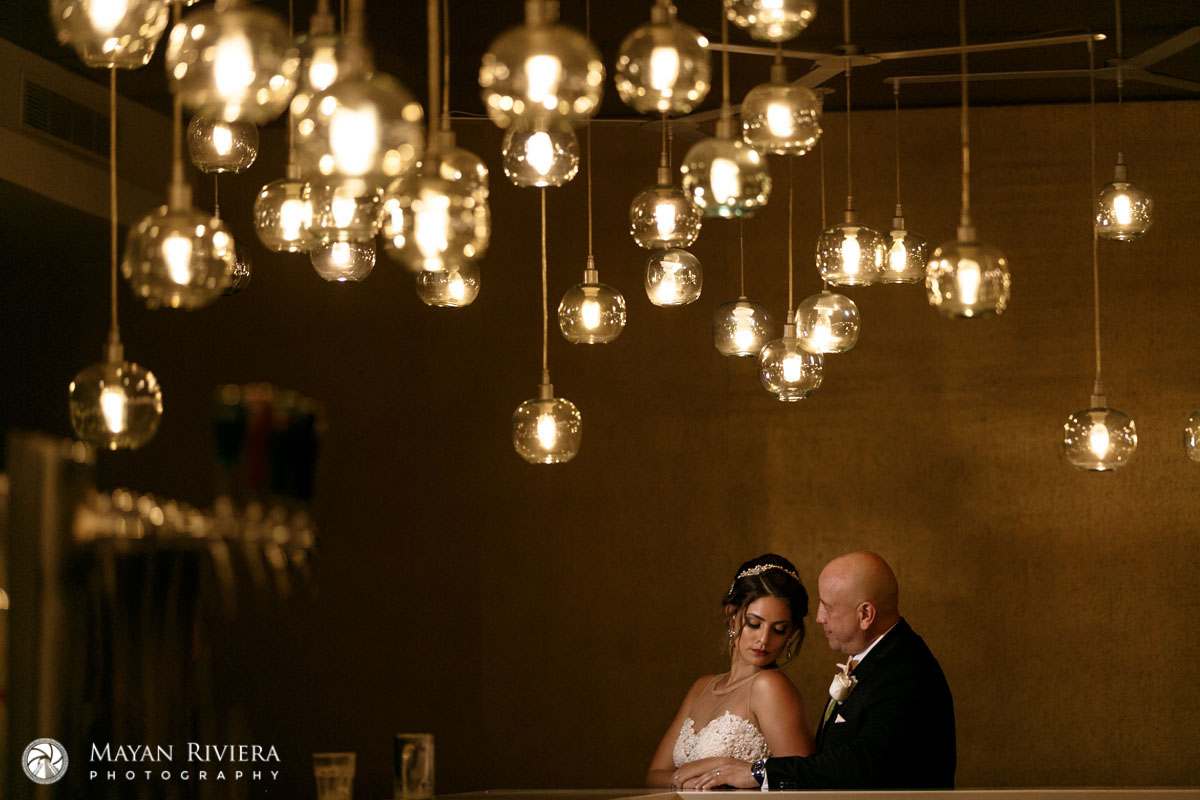 NewlywedsEmbraceUnderGlowingGlobes