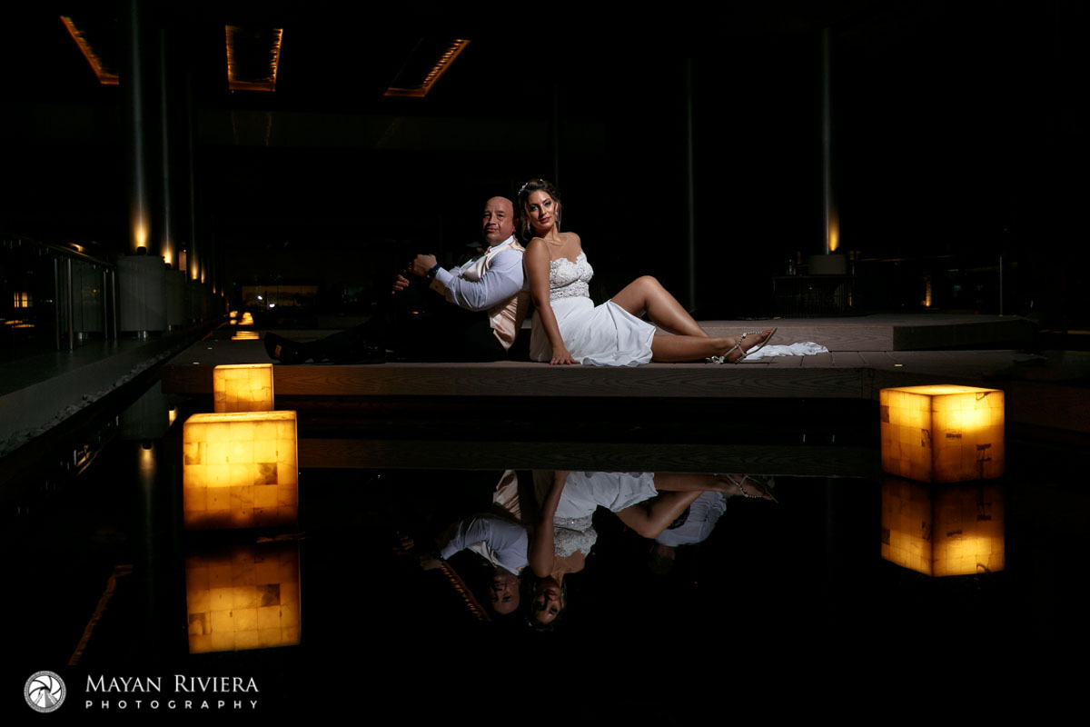 NewlywedsSitBackToBackReflectedInWater