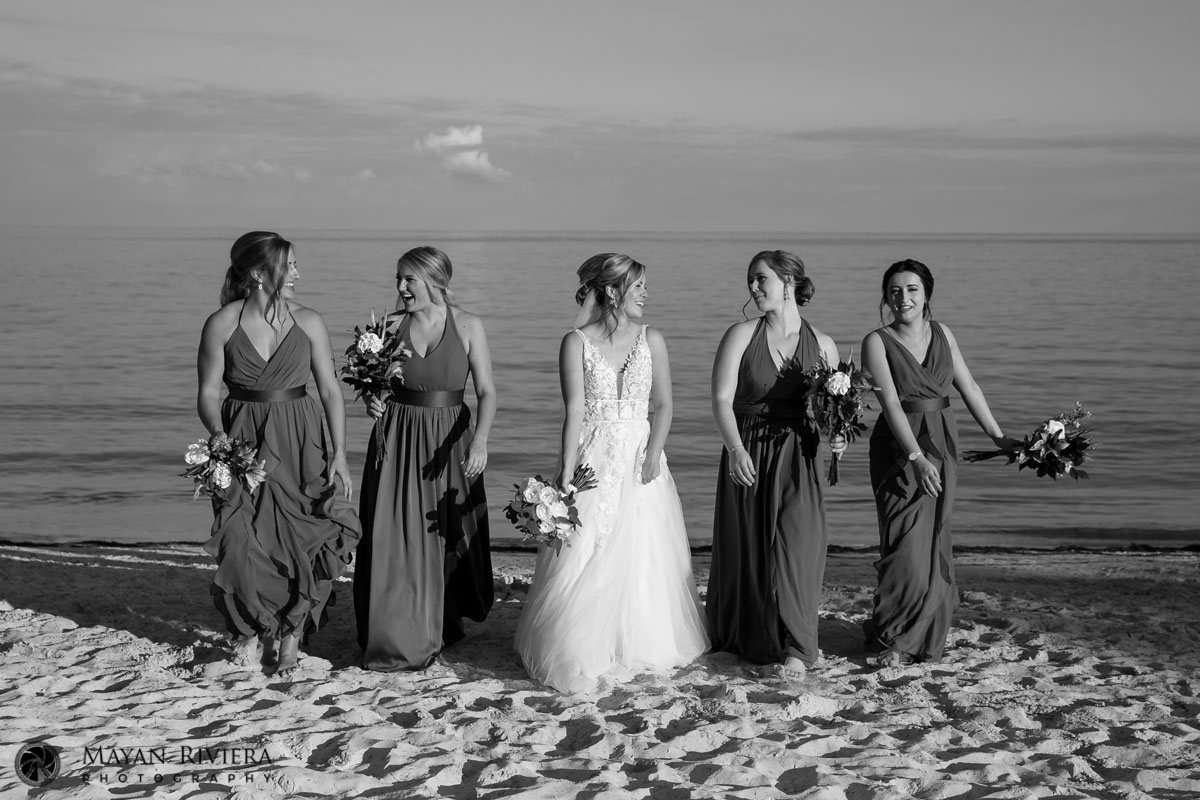BrideAndBridesmaidsStrollOnBeach