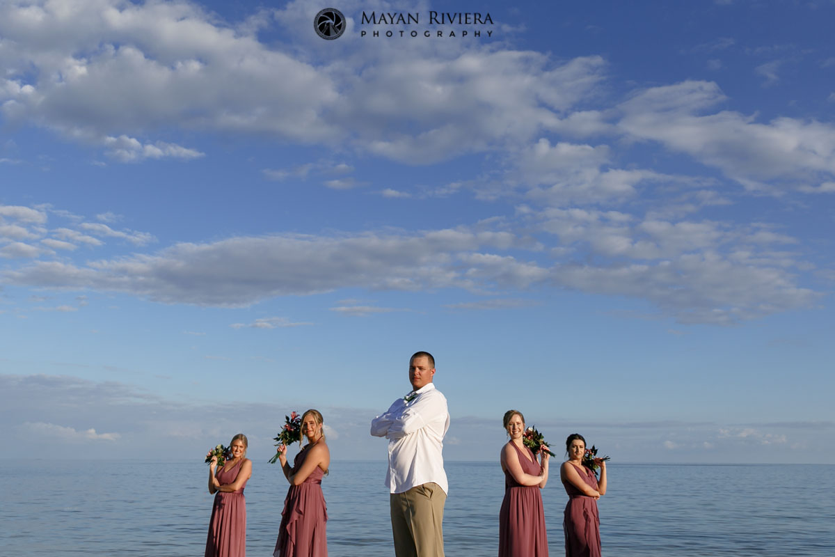 GroomPosesWithGirlsOnBeach