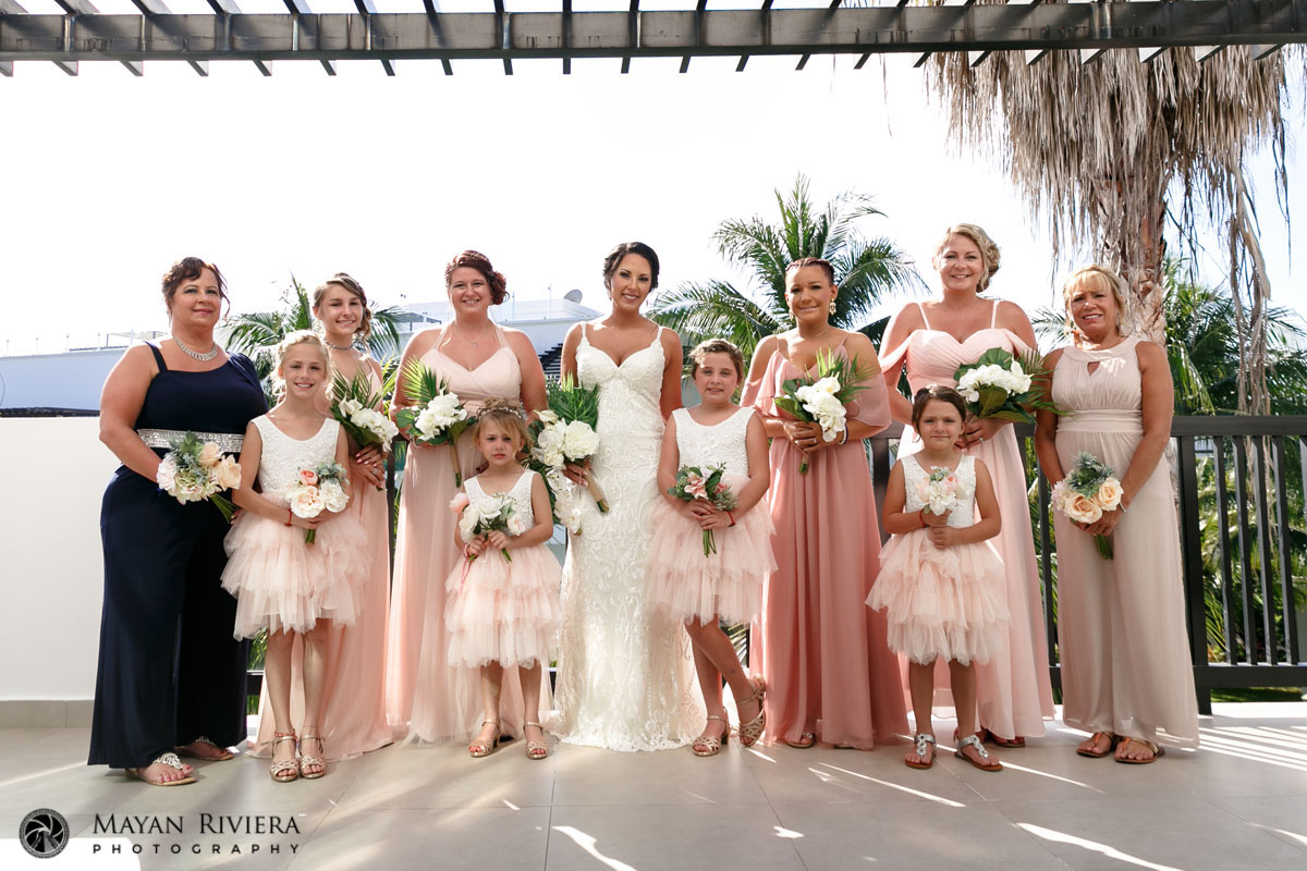 BridePosesOnBalconyWithWeddingParty