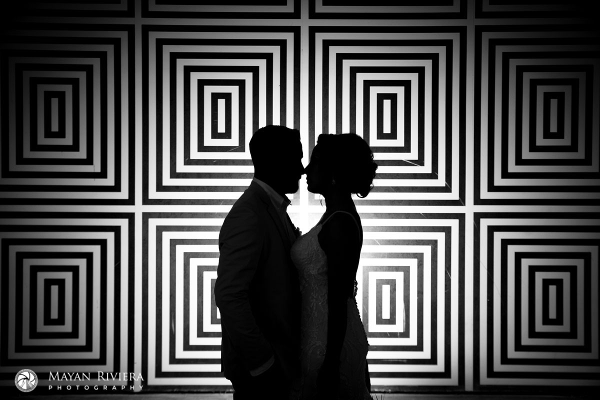 AzulFivesWeddingCoupleShilouettedByDesignWall