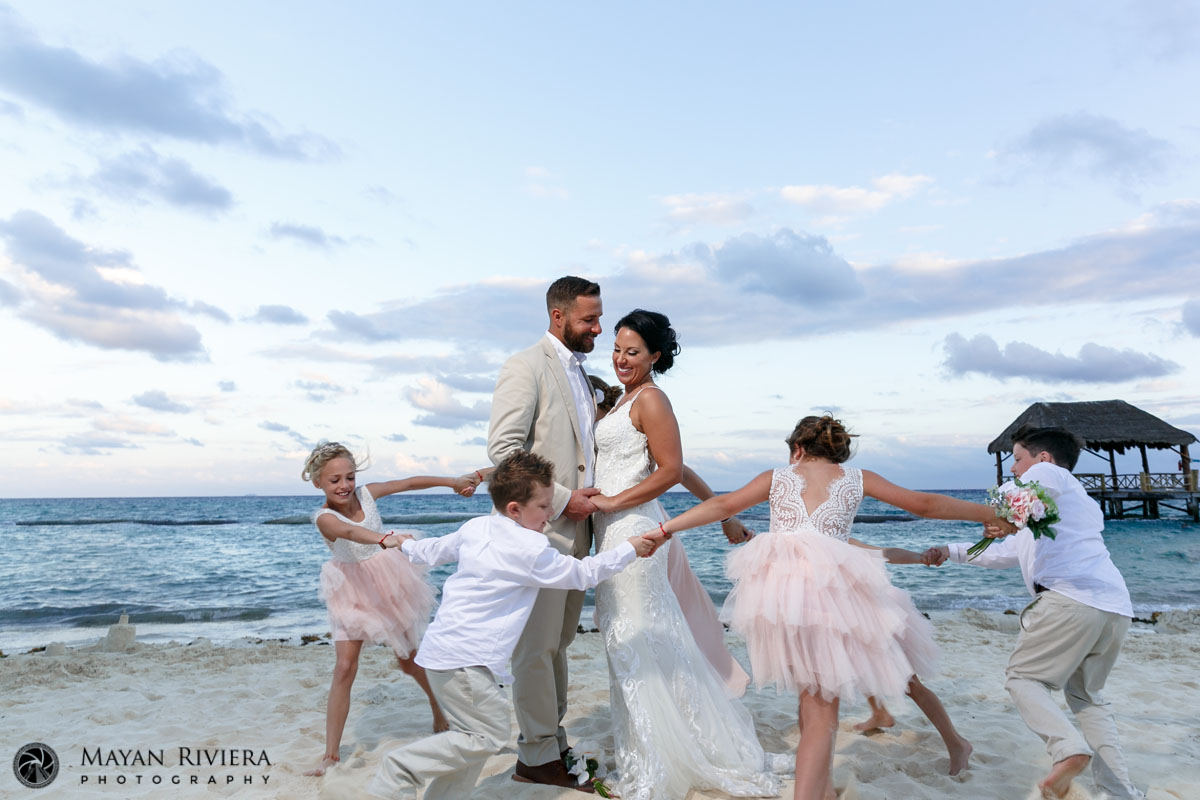 KidsRunningAroundEmbracingParents